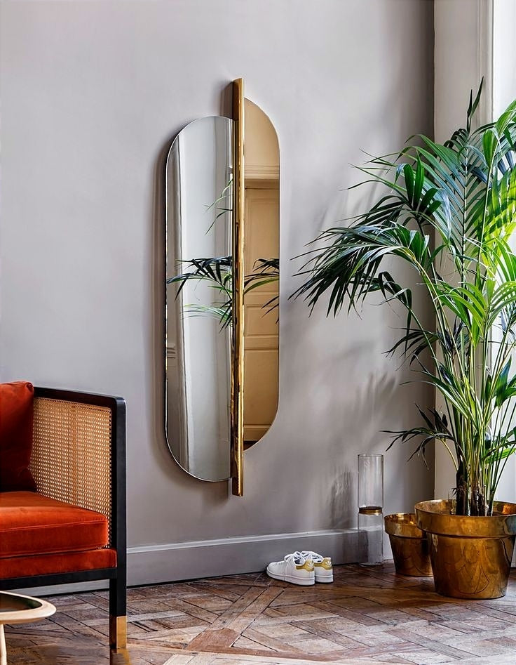 This Luxury Modern Dual-Panel Wall Mirror with Striking Vertical Gold Accent