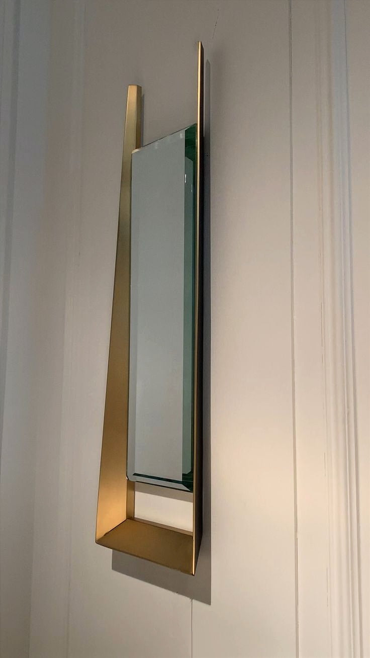 A Modern Flair to Your Home with This Sleek, Minimalist Wall Mirror Featuring a Unique Gold Frame Design